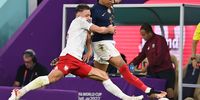 epaselect epa10348392 Kylian Mbappe of France in action against Matty Cash (L) of Poland during the FIFA World Cup 2022 round of 16 soccer match between France and Poland at Al Thumama Stadium in Doha, Qatar, 04 December 2022.  EPA-EFE/Georgi Licovski
