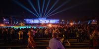 People dance a waltz with the illuminated Schoenbrunn Palace in the background as the Vienna Philharmonic Orchestra performs on stage during the 'Summer Night Concert' (Sommernachtskonzert) at the Schoenbrunn Palace gardens, in Vienna, Austria, 08 June 2023.  EPA-EFE/CHRISTIAN BRUNA