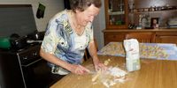 Deftly chopping the roll into rounds. Photo: Margot Patterson