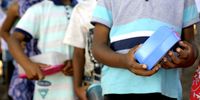 Children queue for food at Compassionate Hearts Soup Kitchen in Touws River, Western Cape.<br>(Photo: Joyrene Kramer)