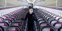 A member of the cabin crew wearing a protective face mask checks cabin seating ahead of the flight on-board a passenger aircraft operated by Wizz Air Holdings Plc at Liszt Ferenc airport in Budapest, Hungary, on Monday, May 25, 2020. Wizz Air is plotting a major expansion at London Gatwick airport as rival carriers pull back, paving the way for the Hungarian low-cost carrier to emerge from the travel downturn with a bigger presence in the worlds busiest city for passenger traffic. Photographer: Akos Stiller/Bloomberg via Getty Images