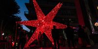 People beneath a huge star at Melrose Arch in Johannesburg, South Africa. The Christmas Lights at Melrose Arch will be on display until 10 January 2021. (Photo: Shiraaz Mohamed)