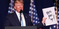 MIAMI, FLORIDA - JANUARY 03: President Donald Trump holds up a sign reading, 'never give up!,' given to him during a 'Evangelicals for Trump' campaign event held at the King Jesus International Ministry on January 03, 2020 in Miami, Florida. The rally was announced after a December editorial published in Christianity Today called for the President Trump's removal from office. (Photo by Joe Raedle/Getty Images)
