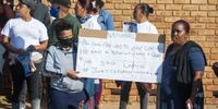 A group of supporters stand outside the Protea Magistrates Court ahead of the appearance of the two police charged with the murder of Nathaniel Julius, 31 August 2020, Soweto, Johannesburg.<br>Photo / Shiraaz Mohamed
