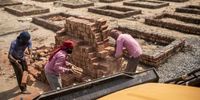 Workers sort bricks while constructing funeral pyre plinths on barren land near a crematorium in New Delhi, India, on Tuesday, April 27, 2021. The U.S. government told its citizens to leave India as soon as possible as the country's Covid-19 crisis worsens at an astonishing pace. Photographer: Anindito Mukherjee/Bloomberg via Getty Images
