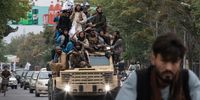 KABUL, AFGHANISTAN - AUGUST 15: Men ride on top of an armored vehicle during a celebration of the first anniversary of the Taliban's return to power on August 15, 2022 in Kabul, Afghanistan. A year after the Taliban retook Kabul, cementing their rule of Afghanistan after a two-decade insurgency, the country is beset by economic and humanitarian crises. Western governments have frozen billions of dollars in Afghan assets as it presses the Taliban to honor unmet promises on security, governance and human rights, including allowing all girls to be educated. (Photo by Nava Jamshidi/Getty Images)