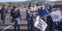 Police warn a tourism protestor in Roeland Street outside parliament that if he does not leave he will be arrested.  (Photo: Brenton Geach)
