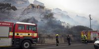 Firefighters keep watch in Glencairn, Cape Town, after houses were destroyed. (Photo: Pete van der Spek)