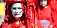 Members of the 'Red Rebels' take part in a Extinction Rebellion protest as they march through the streets of the central business district (CBD) in Brisbane, Queensland, Australia, 15 March 2023. Extinction Rebellion (XR) environmental activists marched through the CBD of Brisbane to protest against the fossil fuel industry.  EPA-EFE/DARREN ENGLAND 