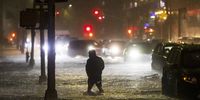 epaselect epa09442152 A man navigates a street flooded by heavy rain as remnants of Hurricane Ida hit the area in the Queens borough of New York, New York, USA, 01 September 2021.  EPA-EFE/JUSTIN LANE