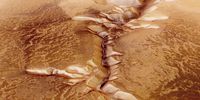 In this handout image supplied by the European Space Agency (ESA) on July 16, 2008, The Echus Chasma, one of the largest water source regions on Mars, is pictured from ESA's Mars Express. The data was acquired on  September 25, 2005. The dark material shows a network of light-coloured, incised valleys that look similar to drainage networks known on Earth. It is still debated whether the valleys originate from precipitation, groundwater springs or liquid or magma flows on the surface.  Image: ESA via Getty Images