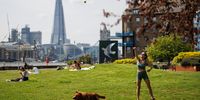 epa11331431 A person spends time with her dog as people enjoy the sunshine in Hermitage Riverside Memorial Garden in London, Britain, 10 May 2024. London is set to have a 'mini-heatwave' this weekend with the temperatures climbing up to 24 Celsius.  EPA-EFE/TOLGA AKMEN