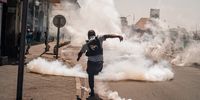 epaselect epa12405384 A protester kicks away a tear gas canister during a rally in Antananarivo, Madagascar, 25 September 2025. Police fired tear gas and rubber bullets to disperse hundreds of protesters demonstrating against recurrent water and power outages.  EPA/HENITSOA RAFALIA