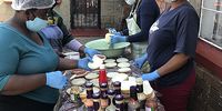 Volunteers preparing the food for the children. Photo: Mark Heywood.