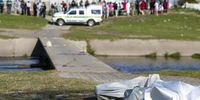 Members of the South African Police Services (SAPS) retrieve the bodies of two women and a man at a low-water pedestrian bridge between Oakdene and Sarepta on September 16, 2021 in Cape Town, South Africa. It is reported that the victims were shot dead in a suspected gang-related attack. (Photo: Gallo Images/Die Burger/Jaco Marais)