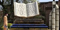 A man walks past a book design of the Martyrs' Monument outside the Shuhada-e-APS Public Library on World Book Day, in Peshawar, Pakistan, 23 April 2024. The World Book and Copyright Day has been observed worldwide on 23 April each year since 1995 when it was first organized by UNESCO. The theme of the 2024 edition is 'Read Your Way', aiming to emphasize on the importance of cultivating a passion for reading.  EPA-EFE/ARSHAD ARBAB