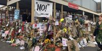 The outside of the Clareinch Post Office, where Uyinene Mrwetyana was killed, was covered in flowers and posters on 9 September 2019. Photo: Karabo Mafolo.