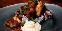 Snails in tomato on a braaied potato, with yoghurt and crème fraiche mixture. (Photo: Philip Potgieter)