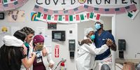 From left, medical staff members Kirbie Standley, Gabriel Cervera Rodriguez, Diana Escalante, Quantavia Love, and Ladarious Styles dance to a Christmas song at nursing station in the COVID-19 intensive care unit (ICU) at the United Memorial Medical Center on December 10, 2020 in Houston, Texas. According to reports, Texas has reached over 1,390,000 cases, including over 23,700 deaths. (Photo by Go Nakamura/Getty Images)