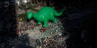 NEW YORK, NY - NOVEMBER 25: Sinclair's Dino balloon floats during the 95th-annual Macys Thanksgiving Day Parade on November 25, 2021 in New York City. (Photo by Kena Betancur/Getty Images)