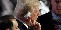 MILWAUKEE, WISCONSIN - JULY 17: Republican presidential candidate, former U.S. President Donald Trump points to his injured ear onstage before the start of the third day of the Republican National Convention in the Fiserv Forum on July 17, 2024 in Milwaukee, Wisconsin. Delegates, politicians, and the Republican faithful are in Milwaukee for the annual convention, concluding with former President Donald Trump accepting his party's presidential nomination. The RNC takes place from July 15-18.  (Photo by Leon Neal/Getty Images)