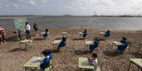 CARTAGENA, SPAIN - MAY 26: Students from Colegio Felix Rodriguez de la Fuente attend their graduation ceremony on Los Nietos beach in the Mar Menor, where they have been developing their classes during the pandemic, on May 26, 2021 in Cartagena, Spain. The open-air learning is part of the Felix Rodriguez de la Fuente school's program of creating healthier environments for school children during the COVID-19 pandemic. (Photo by Alfonso Duran/Getty Images)