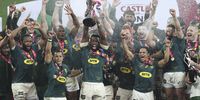 Siya Kolisi of South Africa (centre) raises the series trophy after beating the the British & Irish Lions during the final Test match at Cape Town Stadium on 7 August 2021. (Photo: EPA-EFE / GAVIN BARKER)