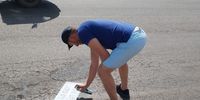 DA member spray painting a road after it was fixed.Photo:Supplied