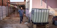 Rajesh Mangar besides his water tank used to store water. 7 September 2022. Lenasia South, Johannesburg. (Photo: Shiraaz Mohamed)