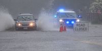 epaselect epa09421061 Cars drive through a flooded street as heavy rains from the remnants of Tropical Storm Fred fall in Saugus, Massachusetts, USA, 19 August 2021.  EPA-EFE/CJ GUNTHER