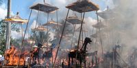 Sarcophagi burn at the cremation site during a Balinese Hindu mass cremation on August 18, 2013 in Ubud, Bali, Indonesia. More than 60 corpses were collectively cremated to share the expense of the ceremony. Well known as Ngaben, it is one of the most important ceremonies for Balinese Hindu people, as they believe it will free the spirit from the deceased body so it can reincarnate. (Photo by Putu Sayoga/Getty Images)