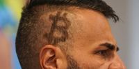 An attendee wtih a Bitcoin logo haircut during the Adopting Bitcoin 2023 Summit in San Salvador, El Salvador, on Tuesday, Nov. 7, 2023. The summit in El Salvador, the world's first nation to make Bitcoin legal tender, comes on the heels of a year-long rally that saw the cryptocurrency climb above $35,000 for the first time since May 2022. Photographer: Camilo Freedman/Bloomberg via Getty Images