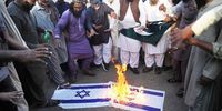 People burn Israeli flags as they take part in a demonstration in solidarity with the Palestinian people in Hyderabad, Pakistan, 11 October 2023. People in different Pakistani cities gathered to show solidarity with the Palestinian people after the Israeli-Palestinian conflict escalated. Thousands of Israelis and Palestinians have died since the militant group Hamas launched an unprecedented attack on Israel from the Gaza Strip on 07 October 2023, leading to Israeli retaliation strikes on the Palestinian enclave.  EPA-EFE/NADEEM KHAWAR