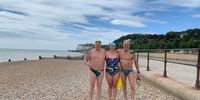 Kat Persson, Jon Vickers and Ross Duncan standing on Dover beach for a training swim. Image: Supplied