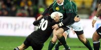 Frans Steyn of the Springboks gets tackled by Dan Carter of the All Blacks during the 2008 Tri Nations series match between the New Zealand All Blacks and the South African Springboks at Westpac Stadium on July 5, 2008 in Wellington, New Zealand.  (Photo by Marty Melville/Getty Images)