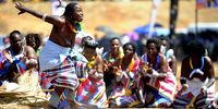 A woman dances to the rhythm of pounding cowhide drums during a dance festival. (Photo: Lucas Ledwaba)