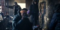 Migrants from Morocco await the moment to cross the border with Croatia inside an abandoned house in Velika Kladusa. Since the closure of the Serbian-Hungarian border to migrants, many have instead chosen to cross from Bosnia into Croatia. However, for many, the dream of a new life turns into a nightmare, and the United Nations High Commissioner for Refugees has called for investigations into reports of violence and excessive use of force. Yet still, every day, dozens of migrants attempt to cross into Croatia from the neighbouring Bosnian city of Bihac, recognisable by their backpacks full of clothes, food and water. The situation worsened over winter, with temperatures reaching minus 15°C, causing the closure of the Vucjak camp, where hundreds of people remained housed in tents. © Jose Manuel Lopez, Spain, Shortlist, Professional, Documentary Projects, 2021 Sony World Photography Awards