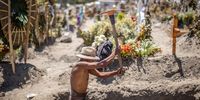 MEXICO CITY, MEXICO - MARCH 25: A gravedigger digs a grave in the San Miguel Xico Cemetery on March 25, 2021 in Valle de Chalco, Mexico. Johns Hopkins University reported yesterday that Mexico reached 199,627 deaths related to COVID-19 and the country could surpass the 200,000 victims today. Mexico is the third country with most reported deaths, only after United States and Brazil, representing one of every five deceases in the world. Since the beginning of the pandemic, 2.208.755 positive cases of coronavirus have been reported in Mexico. According to the National Government, over 6 million vaccines have been administrated to date. (Photo by Hector Vivas/Getty Images)