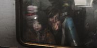 A woman inside an evacuation train at a railway station in Kyiv, Ukraine, on 5 March 2022. According to the UN, at least 1.5 million people have fled Ukraine to neighbouring countries since the beginning of the Russian invasion on 24 February. (Photo: EPA-EFE / Sergey Dolzhenko)