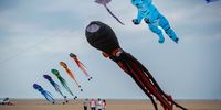 LYTHAM ST ANNES, ENGLAND - SEPTEMBER 02: Kite enthusiasts fly their kites over the beach during the first day of the Lytham St Annes International Kite Festival on September 02, 2022 in Lytham St Annes, England. The three day event will see an array of all sizes and shapes flown by kite fliers. (Photo by Christopher Furlong/Getty Images)