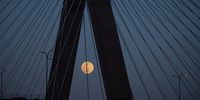 The 'Snow Moon' is seen rising over traffic on the Leonard P Zakim Bunker Hill Bridge in Boston, Massachusetts, USA, 26 February 2021. The full moon in February is called the 'Snow Moon' due to February traditionally being the month with the most snow.  EPA-EFE/CJ GUNTHER