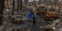 epa09874818 Residents walk past destroyed Russian military machinery on the street, in Bucha, the town which was retaken by the Ukrainian army, northwest of Kyiv, Ukraine, 06 April 2022. Hundreds of tortured and killed civilians have been found in Bucha and other parts of the Kyiv region after the Russian army retreated from those areas. Russian troops entered Ukraine on 24 February resulting in fighting and destruction in the country, and triggering a series of severe economic sanctions on Russia by Western countries.  EPA-EFE/ROMAN PILIPEY
