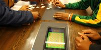 School teams use an app and scannable puzzle pieces to participate in the ‘Coding4Mandela’ event at Cape Town’s Central Library. (Photo: Tamsin Metelerkamp)