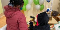 Rodwell and his mom, Shamiso Mabika, play with a toy car in his ward. (Photo: Maqshuda Kajee)