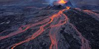 In this aerial view, Fargradalsfjall volcano spews molten lava on August 19, 2021 near Grindavik, Iceland. Iceland is feeling a strong impact from global warming. While the volcano, which erupted in March of this year, lies in the volcanic lowlands southwest of Reykjavik, other Icelandic volcanoes lie under the island's large ice caps, such Eyjafjallajokull, which erupted in 2010. Since the 1990s 90% of Iceland's glaciers have been retreating and projections for the future show a continued and strong retreat in size of its three ice caps. The reduction in mass and pressure from the melting ice caps is increasing the likelihood of further seismic and volcanic activity.  (Photo by Sean Gallup/Getty Images)