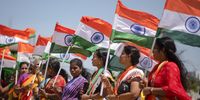Supporters of the Bharatiya Janata Party (BJP) hold national flags during a boat rally to celebrate the 75th Independence Day of India, at Neelangarai beach, in Chennai, India on 10 August 2022. (Photo: EPA-EFE / Idrees Mohammed)