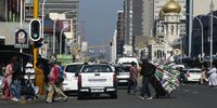 A man pulls a trolley with loads of mealie meal in the busy street of Dr Yusuf Dadoo Street in Durban. (Photo: Felix Dlangamandla)
