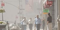 People rush away from the collapsing World Trade Center September 11, 2001 after two hijacked airplanes ran into the two towers in New York City in an apparent terrorist attack. (Photo by Spencer Platt/Getty Images)