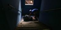 A man removes bags of refuse to be taken to a central point for removal. (Photo: Shiraaz Mohamed)