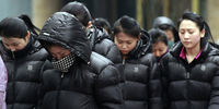A group of North Korean women in the streets of Dandong, China in March 2023 being overseen by a government minder. The use of such workers in China is in violation of U.N. sanctions. (Credit: © Living in North Korea/The Outlaw Ocean Project, March 2023)